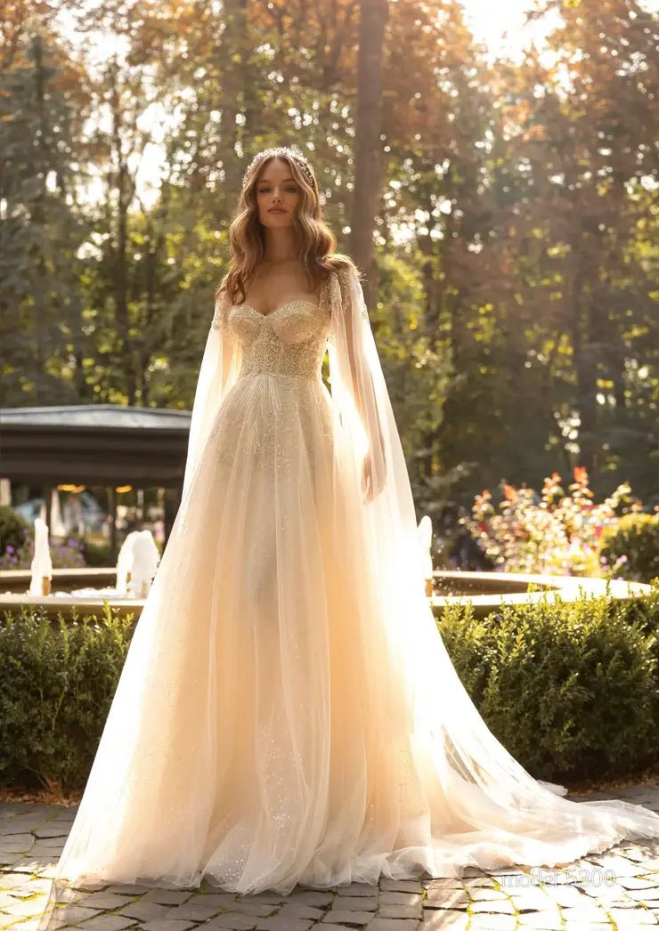 GENIVEVE Corset style beaded bodice with beaded tulle skirt. Shoulder drapes/ cape - Reflections Bridal Studio