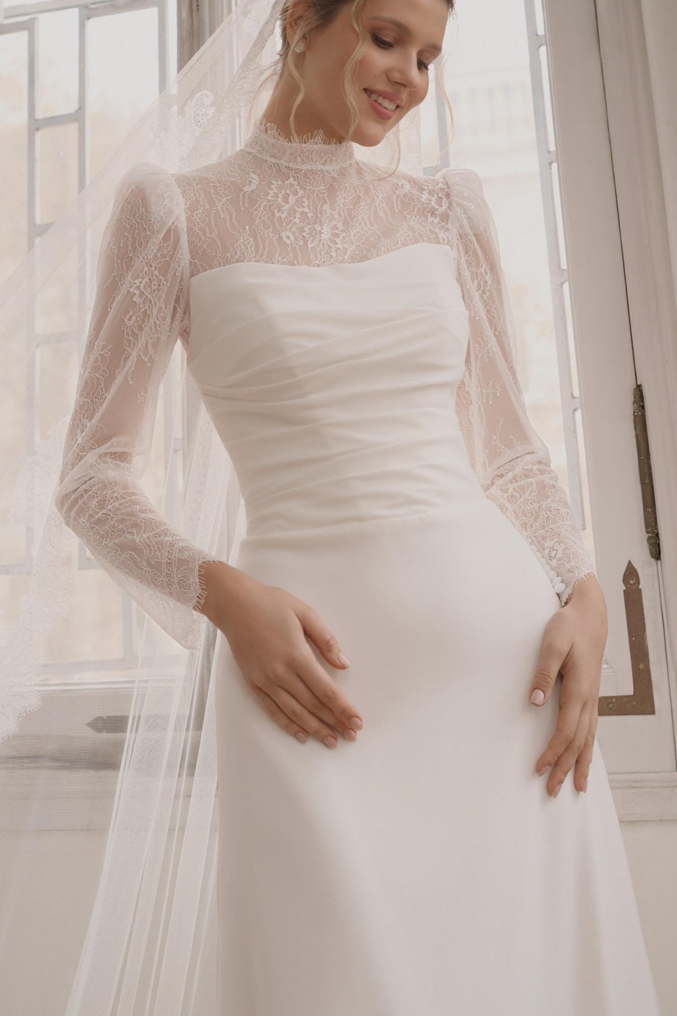 JULIANNA Lace high neckline and long sleeves on a crepe gown - Reflections Bridal Studio