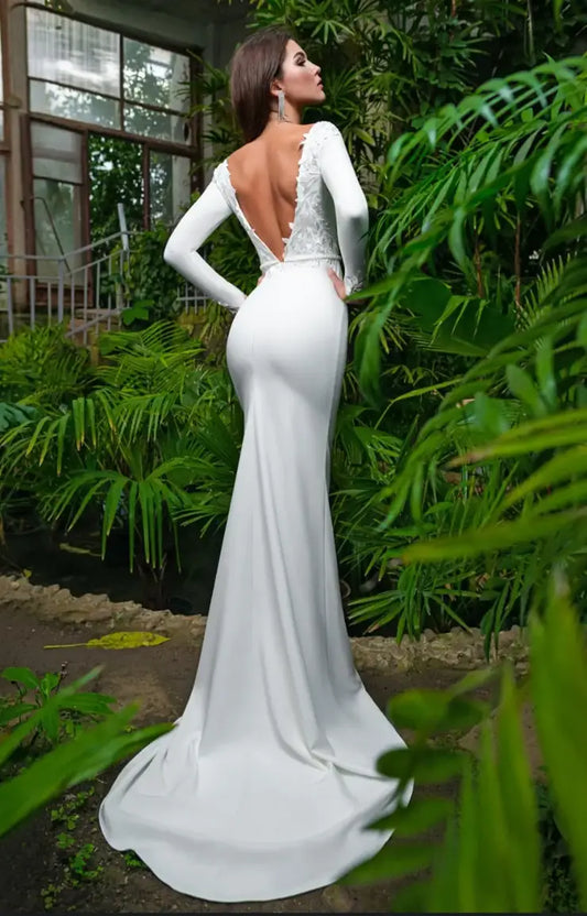 #LAGUNA A fitted jersey wedding dress with low back and fitted sleeves. Beaded belt and lace detail