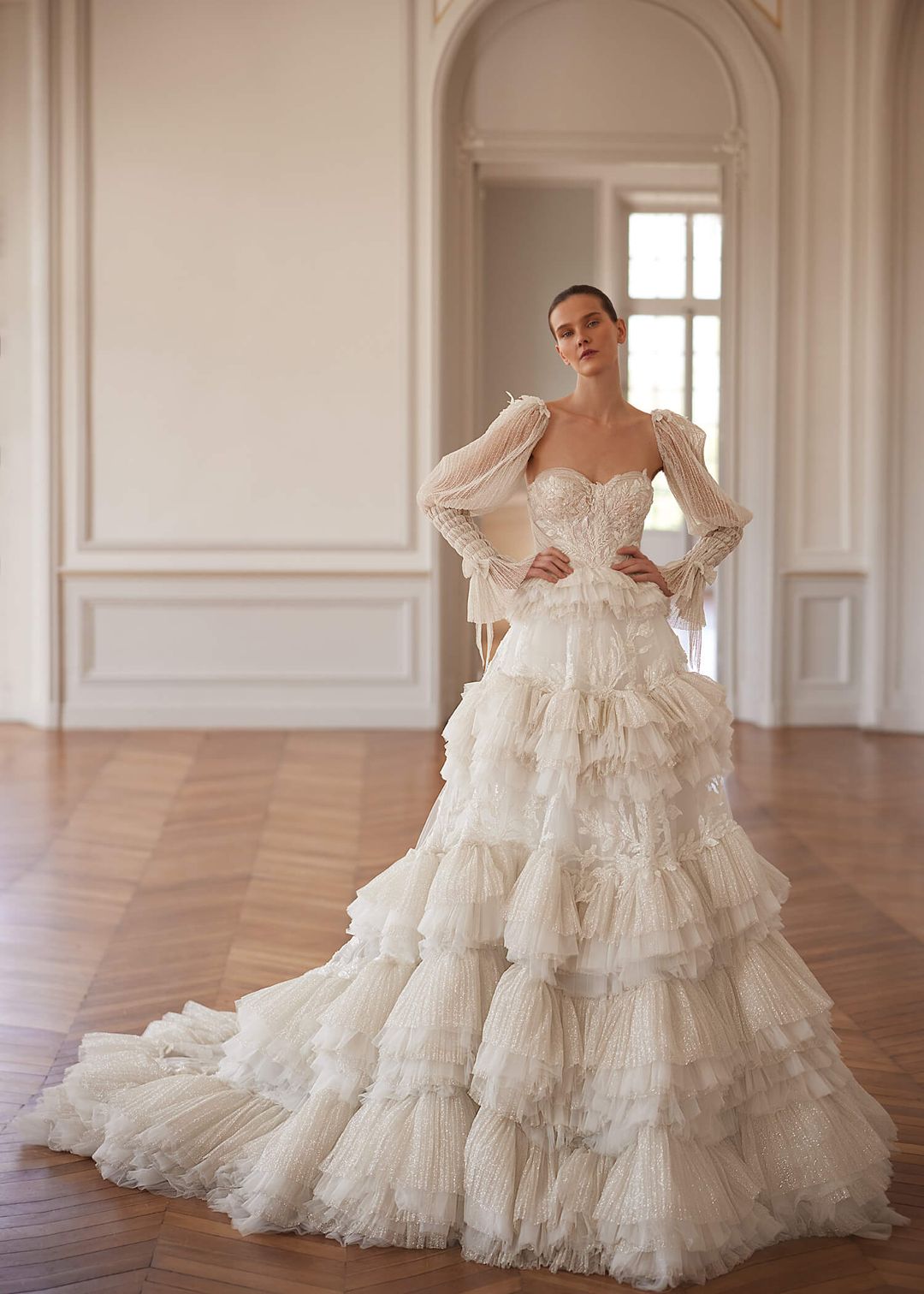 BASSEMA Indulgent layers of ruffles with glitter and lace. Detachable sleeves - Reflections Bridal Studio