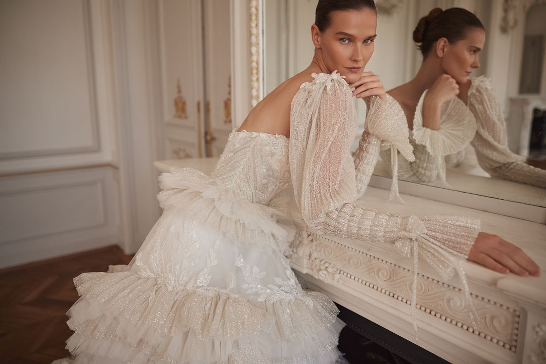 BASSEMA Indulgent layers of ruffles with glitter and lace. Detachable sleeves - Reflections Bridal Studio
